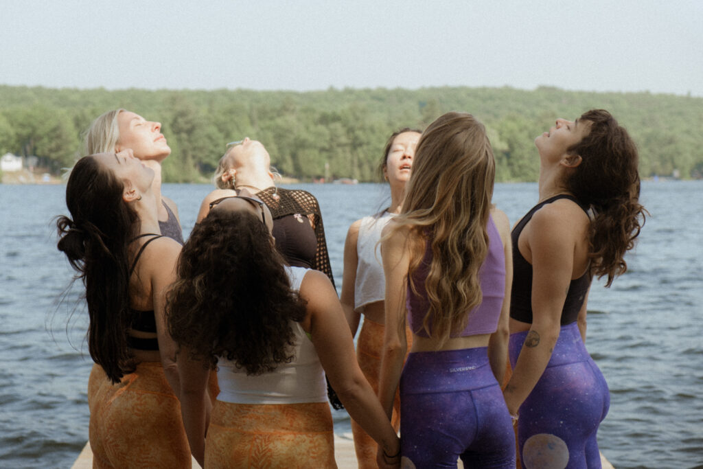 Women standing together in a circle on the dock