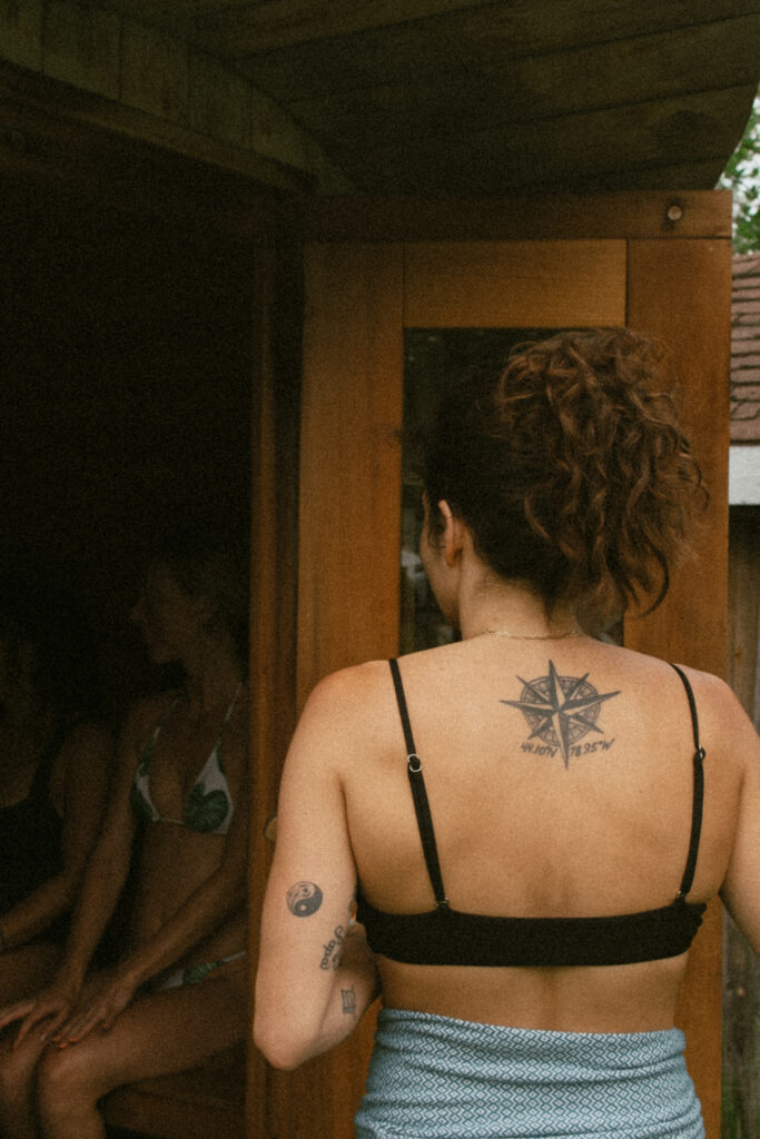 Woman walking into an outdoor sauna
