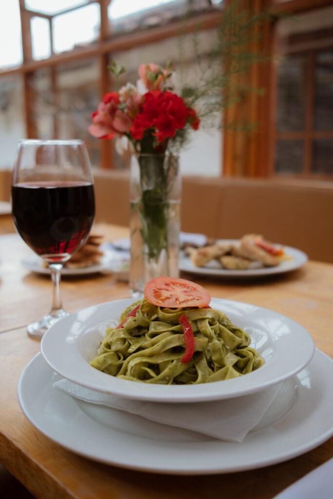 Pesto pasta and glass of wine